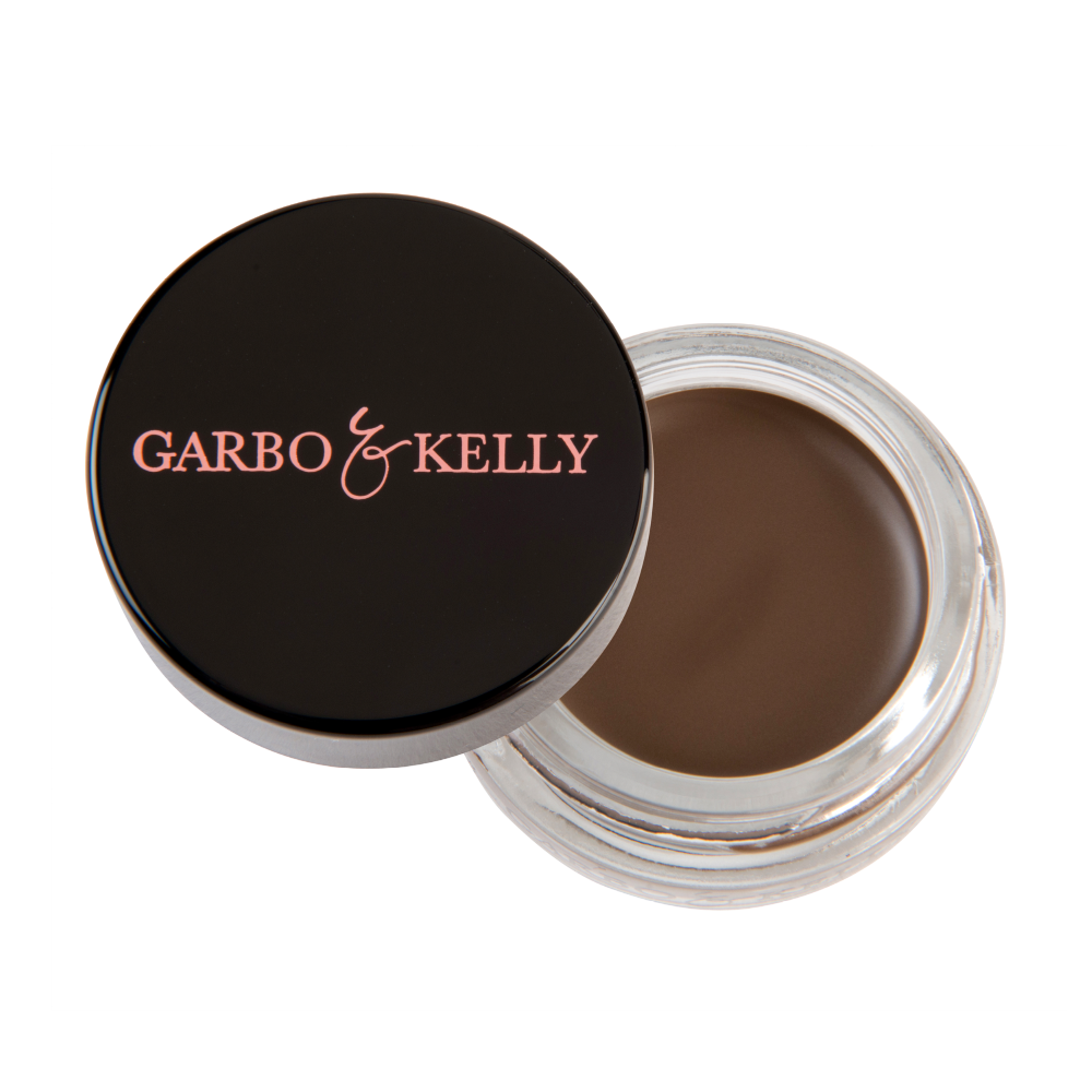 Garbo and Kelly brow pomade in a small jar, showing the smooth, creamy texture ideal for defining and filling in eyebrows.