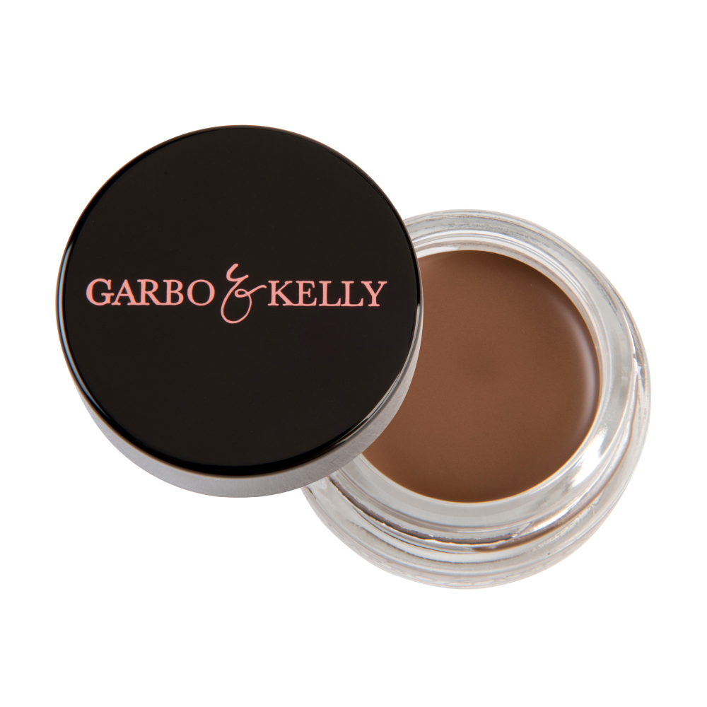 Garbo and Kelly brow pomade in a sleek jar, showcasing rich, creamy formula perfect for defining and shaping eyebrows.