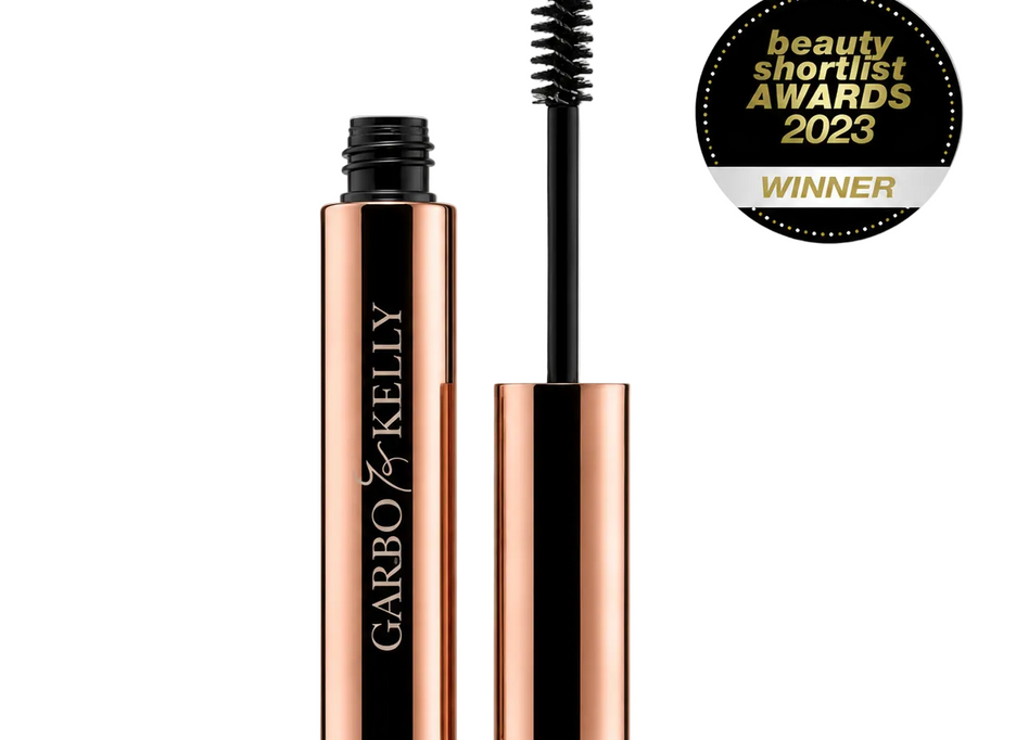 Close-up of Garbo & Kelly Brow Gel tube with the product label and applicator brush visible.