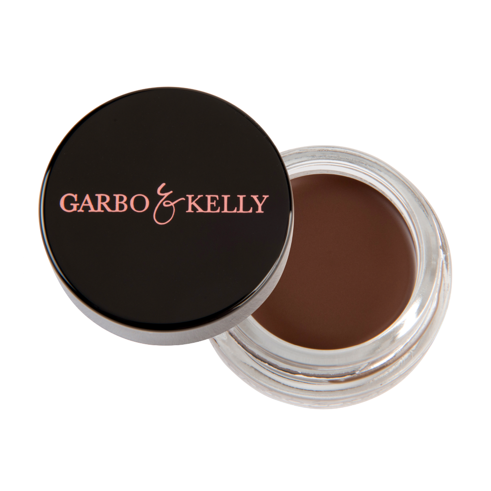 Garbo and Kelly brow pomade in a jar, showcasing the creamy, pigmented brow styling product with a smooth texture and neutral shade.