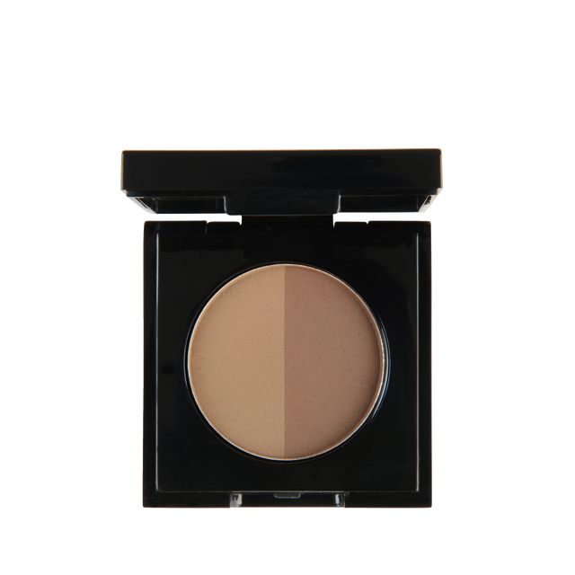 Close-up of Garbo and Kelly Brow Powder in a compact, showing the rich, pigmented powder and applicator brush for brow makeup.