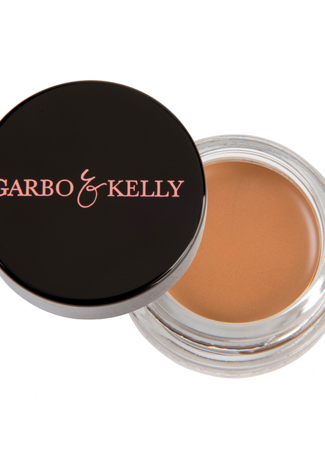 Garbo and Kelly brow pomade in a sleek jar, showcasing smooth, creamy formula for defining and shaping eyebrows.