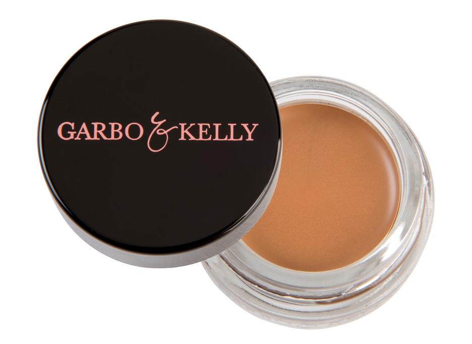 Garbo and Kelly brow pomade in a sleek jar, showcasing smooth, creamy formula for defining and shaping eyebrows.